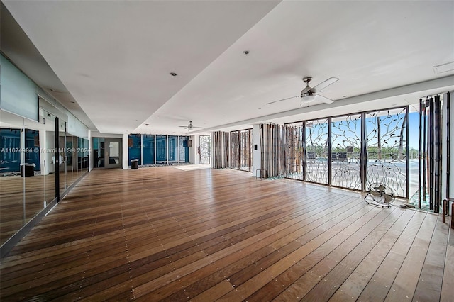 spare room with a water view, ceiling fan, and wood-type flooring