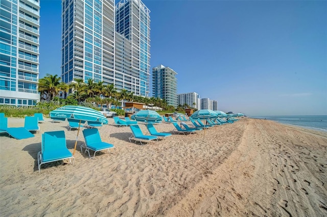 exterior space with a water view and a view of the beach