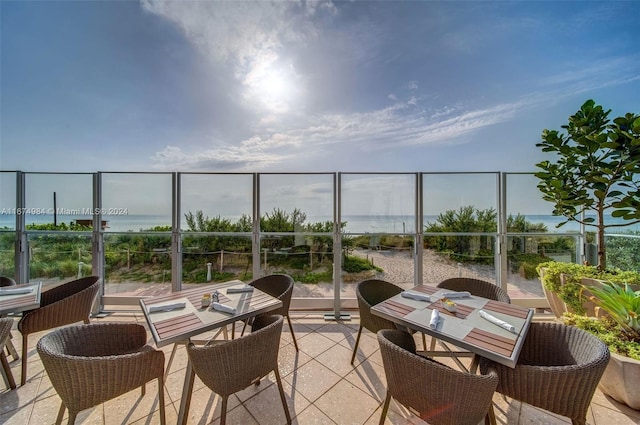 balcony featuring a water view and a patio