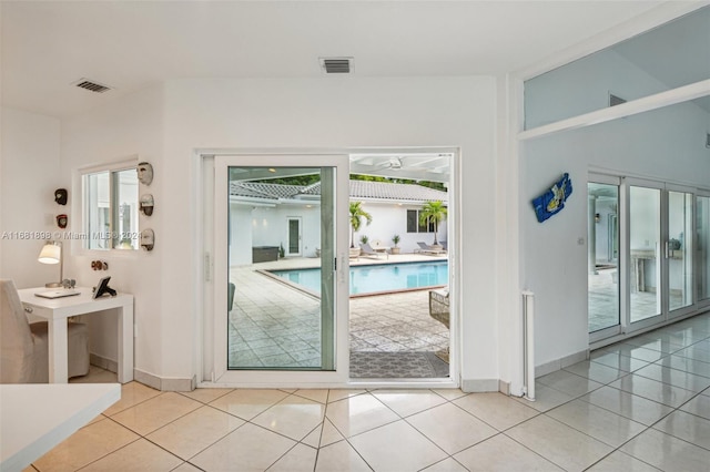 entryway featuring light tile patterned flooring and a healthy amount of sunlight