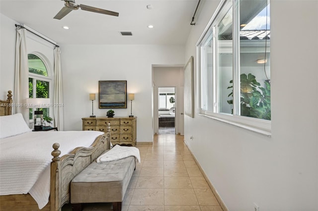 bedroom with multiple windows, light tile patterned floors, and ceiling fan