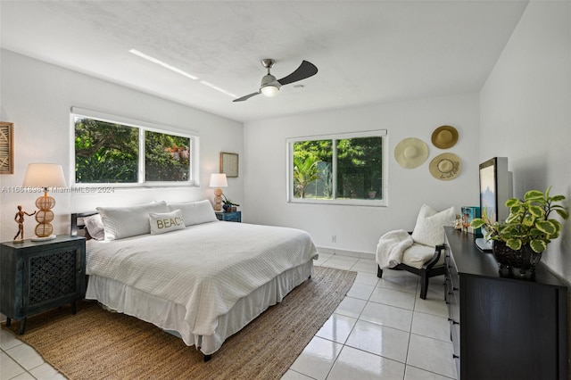 bedroom with ceiling fan and light tile patterned floors