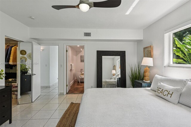 tiled bedroom featuring a closet, ceiling fan, and ensuite bathroom