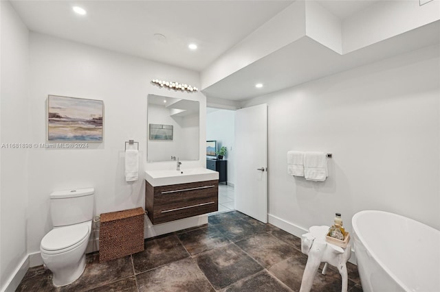 bathroom with vanity, toilet, and a bath