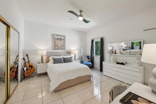 tiled bedroom featuring a closet and ceiling fan