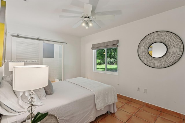 tiled bedroom featuring ceiling fan