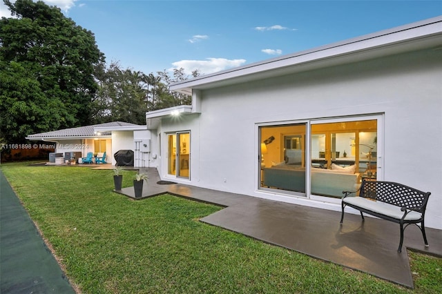 rear view of property with a patio area and a lawn