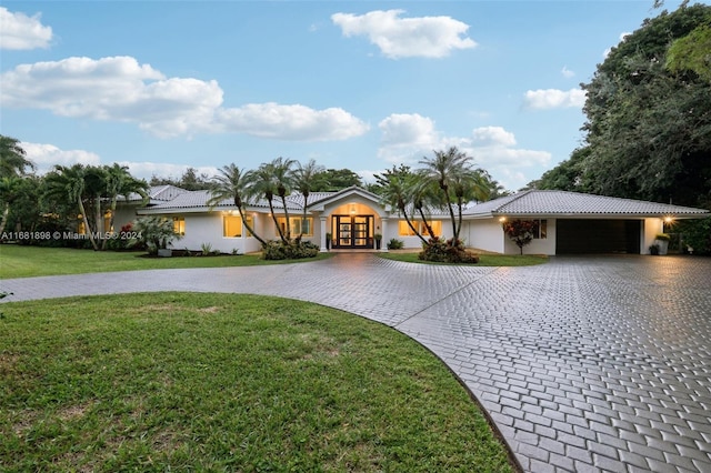 ranch-style home with a front lawn