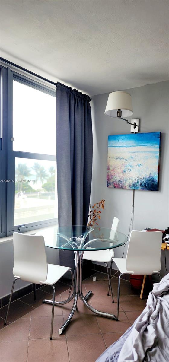 dining room featuring tile patterned floors and a healthy amount of sunlight