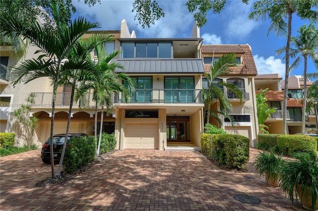 view of front of property with a balcony and a garage