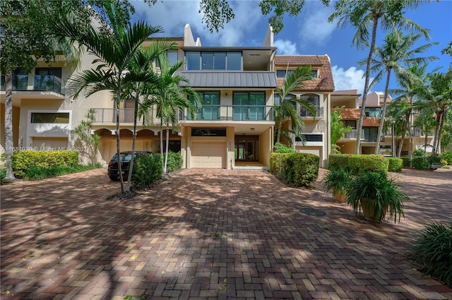 view of front facade featuring a balcony and a garage