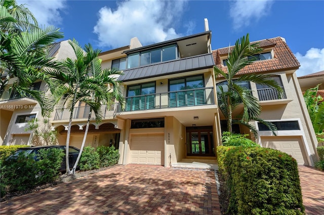 view of front of home featuring a balcony and a garage