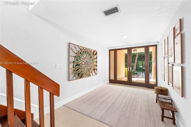 interior space featuring french doors and light tile patterned flooring