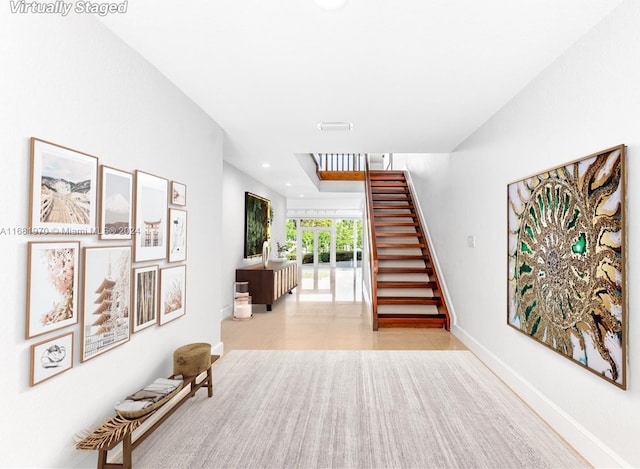 stairway with tile patterned floors