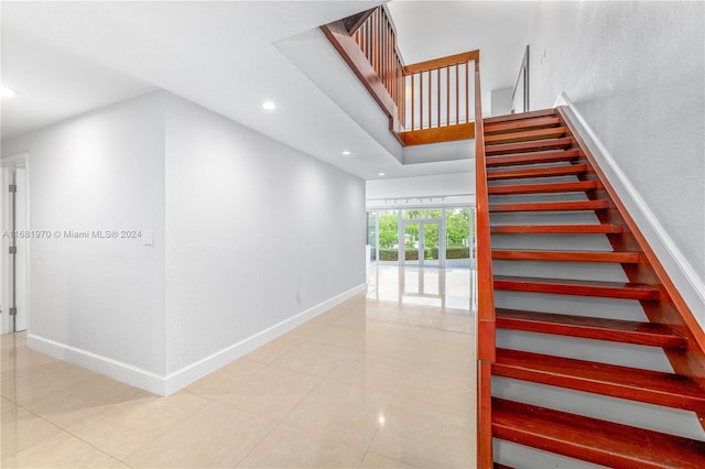 stairway featuring tile patterned floors