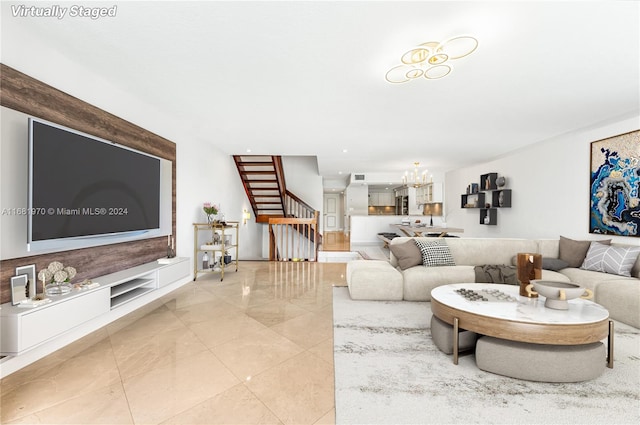 living room with a notable chandelier and light tile patterned flooring