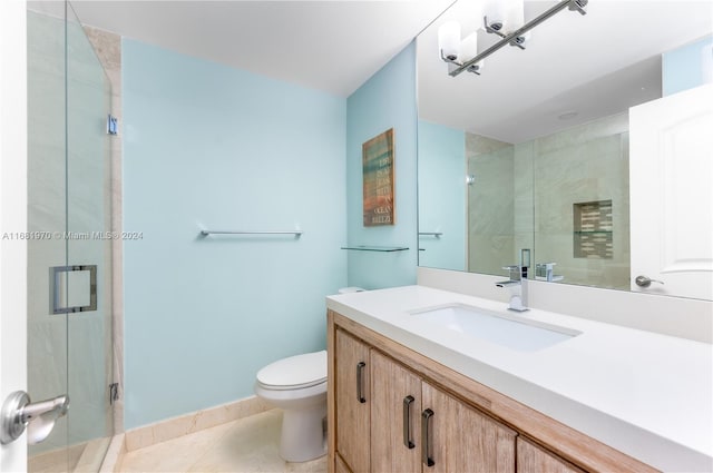 bathroom with toilet, an enclosed shower, vanity, and tile patterned flooring