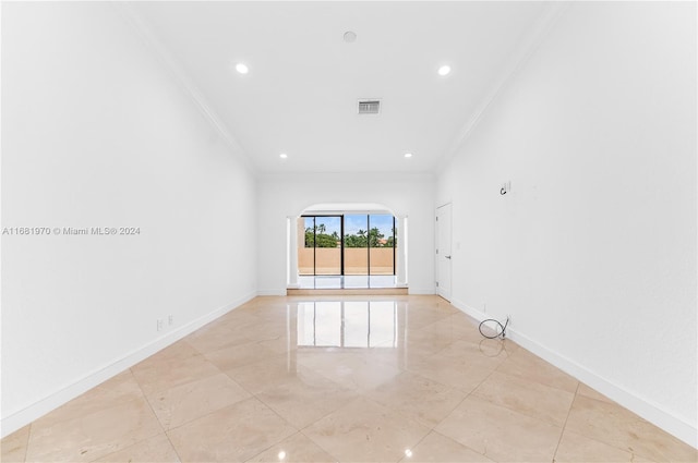 tiled spare room with crown molding