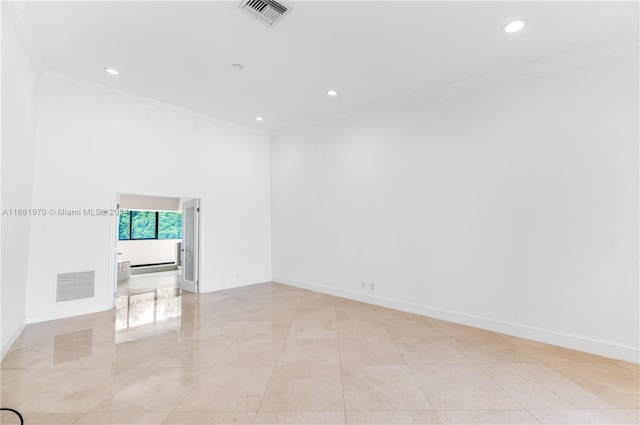 empty room featuring crown molding and light tile patterned floors