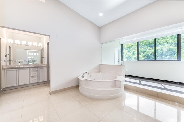 bathroom with vanity, lofted ceiling, a bathtub, and tile patterned flooring