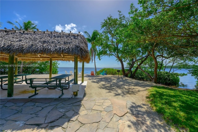 view of community featuring a patio, a gazebo, and a water view