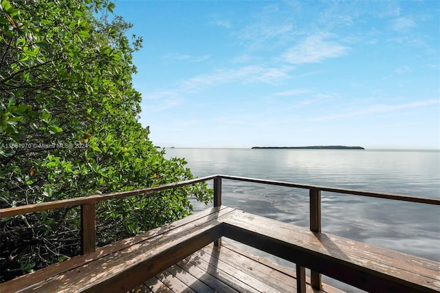 wooden deck featuring a water view