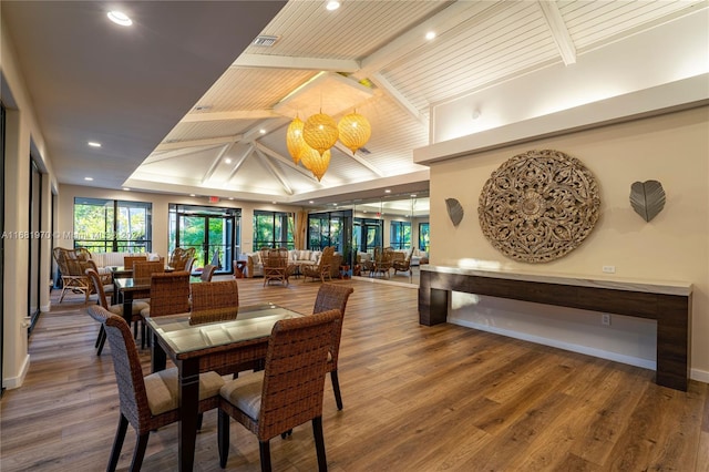 dining area featuring vaulted ceiling with beams, wood ceiling, and hardwood / wood-style floors