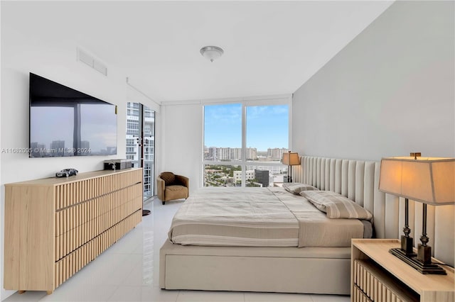 bedroom featuring light tile patterned floors and floor to ceiling windows