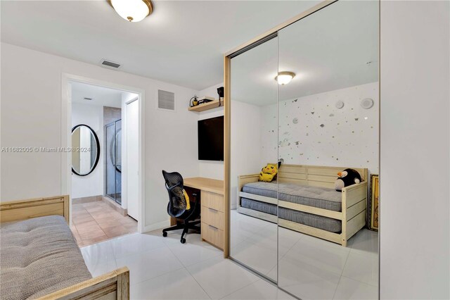 18201 Collins Ave Unit 1905, Sunny Isles Beach, FL 33160 - bedroom featuring an office area, light tile patterned flooring, and baseboards