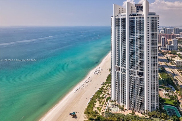 bird's eye view featuring a water view and a beach view