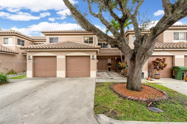2394 NW 97th Way Unit 2394, Pembroke Pines, FL 33024 - view of front facade with stucco siding, concrete driveway, a tiled roof, and an attached garage