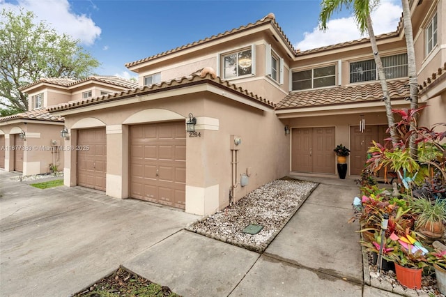 2394 NW 97th Way Unit 2394, Pembroke Pines, FL 33024 - view of front of home with stucco siding, a garage, a tiled roof, and driveway