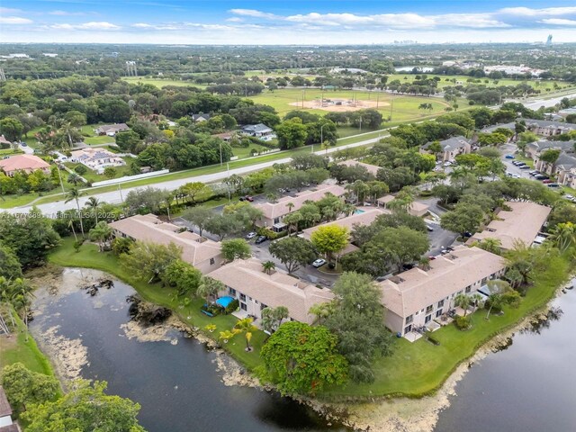 2394 NW 97th Way Unit 2394, Pembroke Pines, FL 33024 - aerial perspective of suburban area featuring a nearby body of water and a tree filled landscape