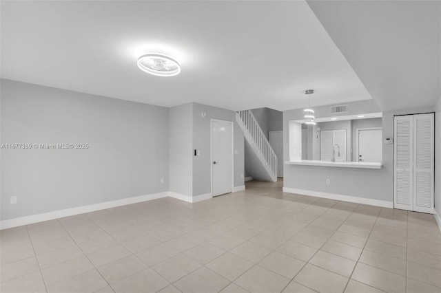 2394 NW 97th Way Unit 2394, Pembroke Pines, FL 33024 - unfurnished living room with light tile patterned flooring and stairway
