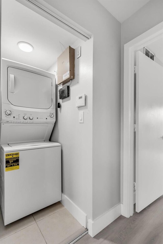 2394 NW 97th Way Unit 2394, Pembroke Pines, FL 33024 - laundry room featuring stacked washer / dryer and baseboards