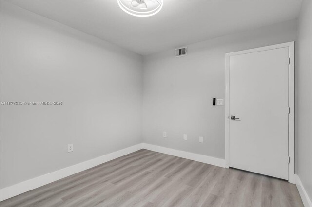 2394 NW 97th Way Unit 2394, Pembroke Pines, FL 33024 - empty room featuring wood finished floors and baseboards