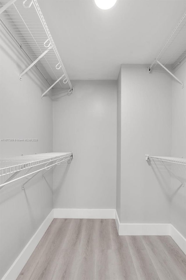 2394 NW 97th Way Unit 2394, Pembroke Pines, FL 33024 - spacious closet featuring wood finished floors