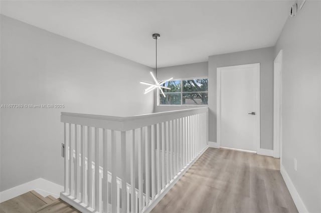 2394 NW 97th Way Unit 2394, Pembroke Pines, FL 33024 - corridor with a chandelier, an upstairs landing, and wood finished floors