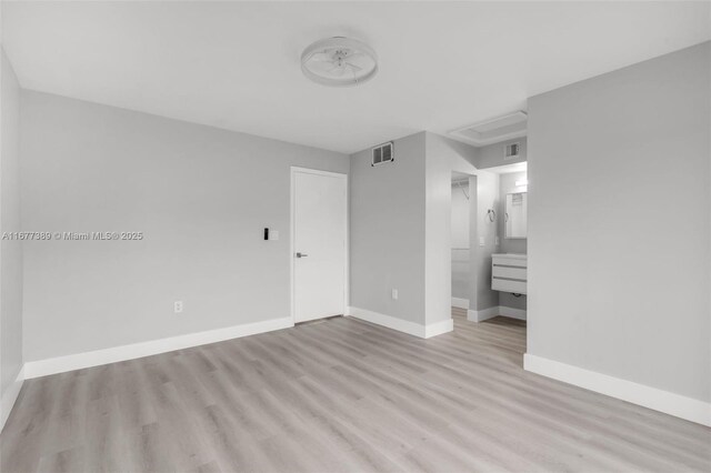 2394 NW 97th Way Unit 2394, Pembroke Pines, FL 33024 - unfurnished bedroom with light wood-style flooring and ensuite bathroom