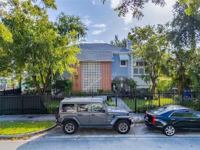 405 SW 11th Ave, Miami, FL 33130 - view of front facade featuring roof with shingles and a chimney