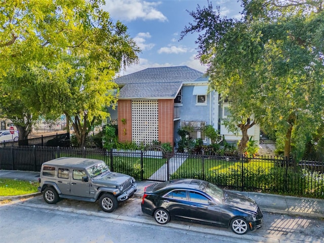405 SW 11th Ave, Miami, FL 33130 - view of front of property featuring a shingled roof and uncovered parking