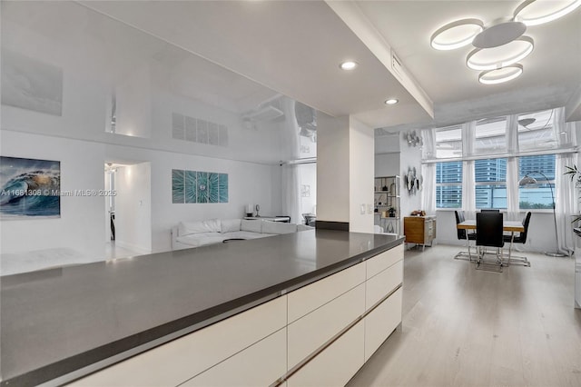 kitchen with white cabinetry and light hardwood / wood-style floors