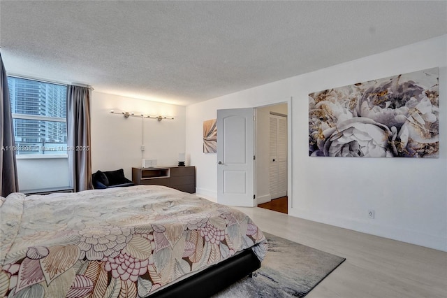 bedroom featuring a textured ceiling and hardwood / wood-style flooring