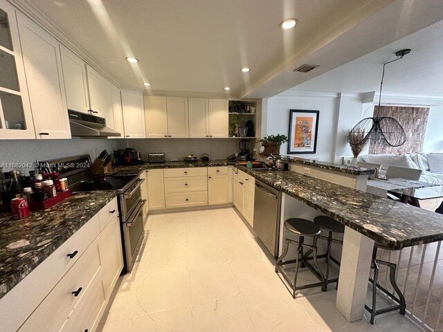 199 Ocean Lane Dr Unit 613, Key Biscayne, FL 33149 - kitchen featuring a kitchen bar, visible vents, appliances with stainless steel finishes, a sink, and a peninsula