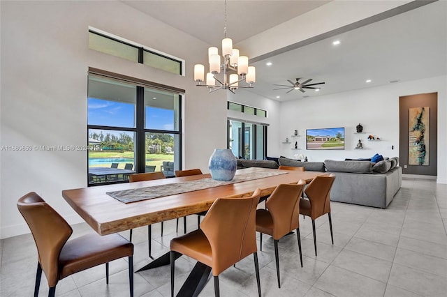 tiled dining area with ceiling fan with notable chandelier