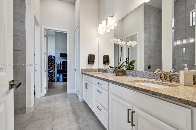 bathroom featuring a tile shower, vanity, ceiling fan, and tile patterned floors