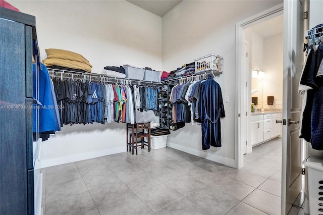 spacious closet with light tile patterned floors