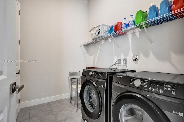 washroom with separate washer and dryer and light tile patterned floors