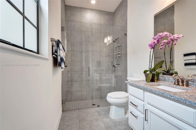 full bath featuring a stall shower, tile patterned flooring, vanity, and toilet