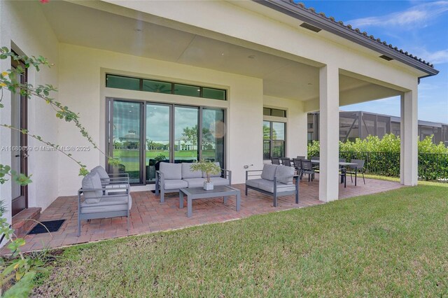 back of property with a lawn, a patio area, and an outdoor living space